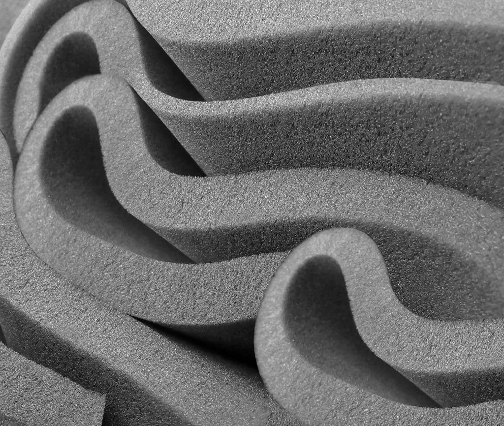 rolled gray foam sponge. foam sponge rubber texture sheet. irregular folds of material blown film extrusion